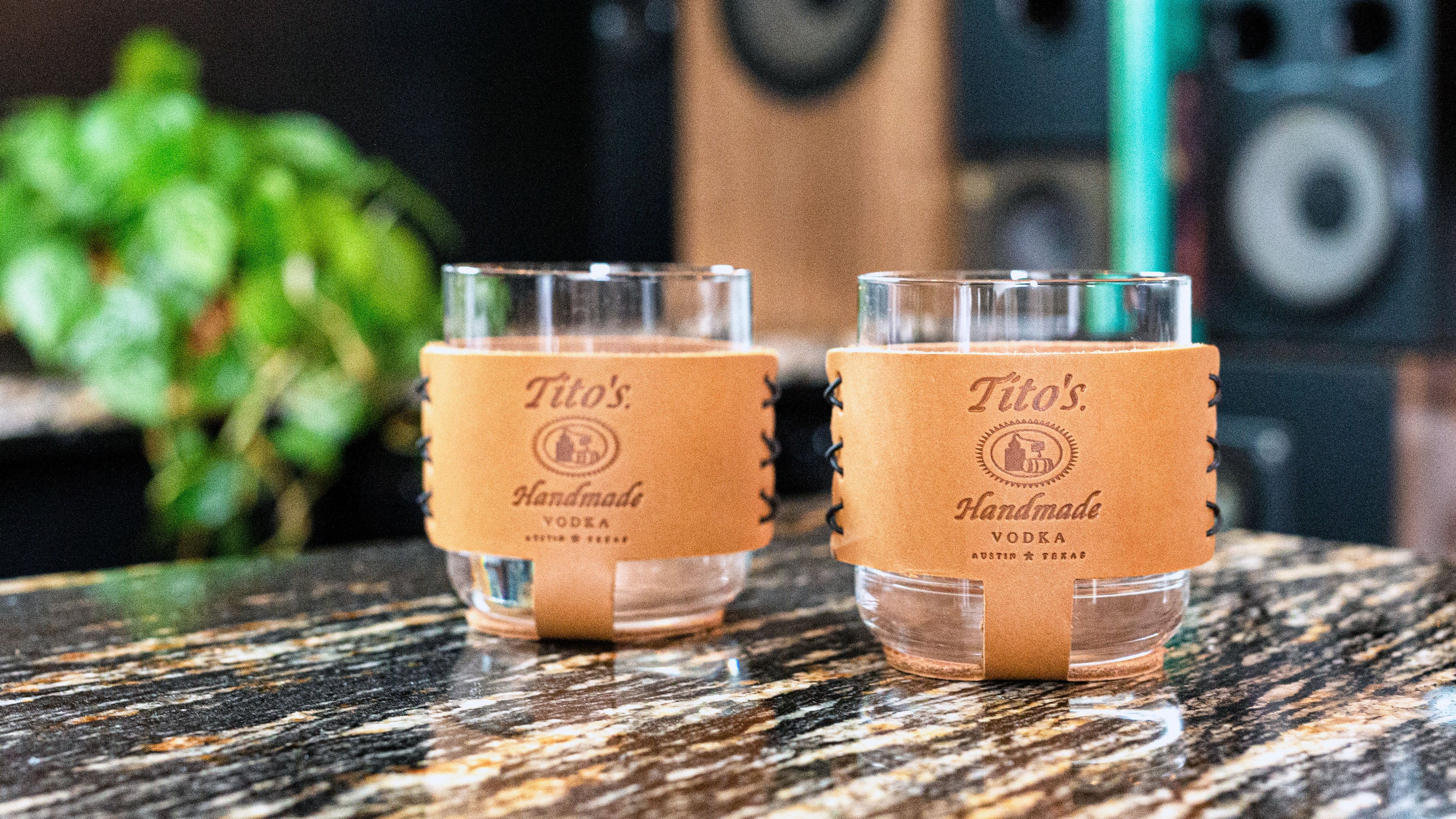 2 glass rocks glass in leather coasters with the Tito's Handmade Vodka logo stamped on