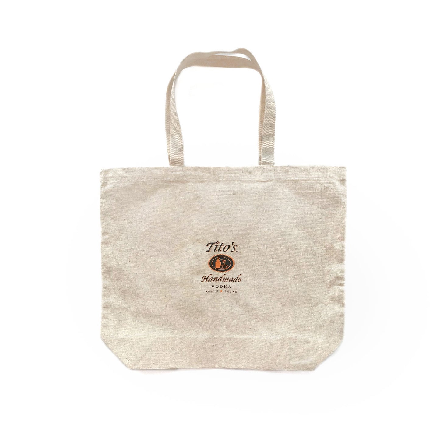 A beige cotton tote bag with the 'Tito's Handmade Vodka' logo printed in orange and black.