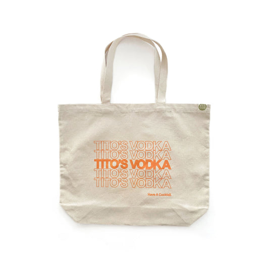 A beige cotton tote bag with the text 'Tito's Vodka' printed in orange.