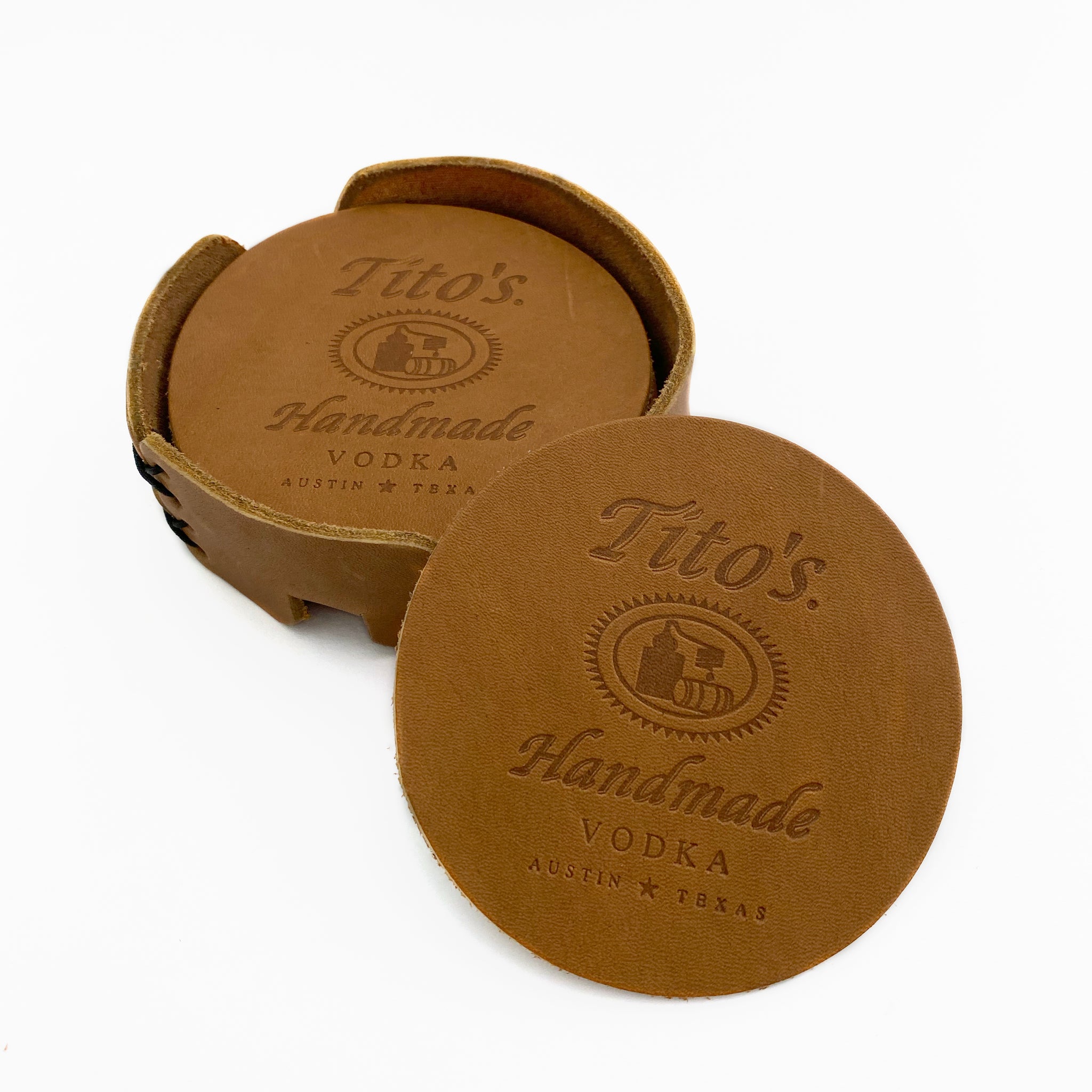 Set of leather coasters branded with Tito’s Handmade Vodka logo and coaster holder