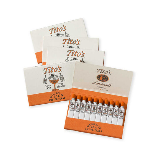 5 packs of matchbooks with the Tito's Handmade Vodka logo and logo with an armadillo in a martini glass on the packaging. The strikes are white with the Tito's bottle printed on each one.