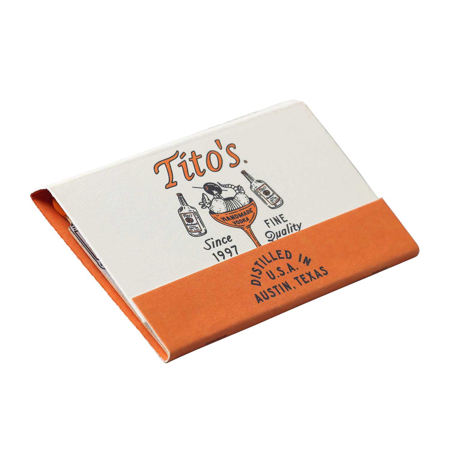 Front image of a closed Tito's Handmade Vodka branded matchbook with orange and white design of and armadillo holding an olive in a martini glass. 