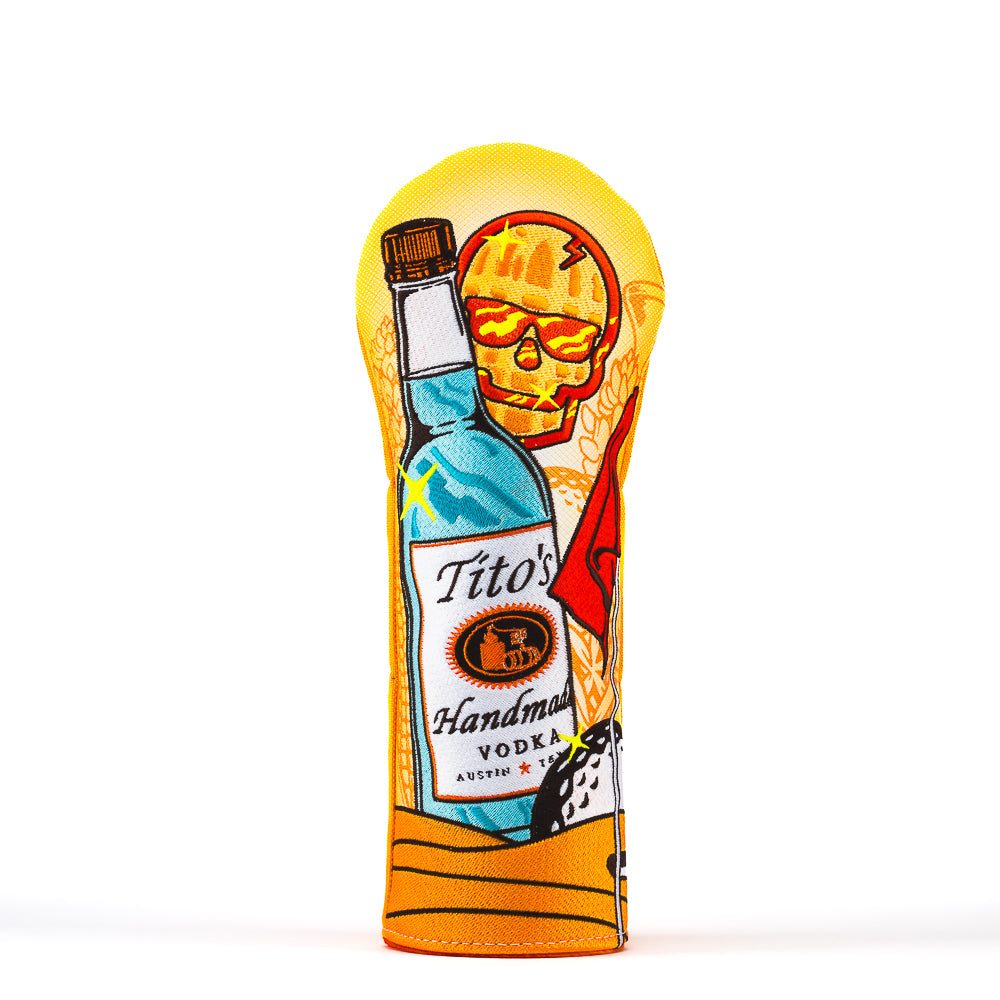 Front of orange and yellow fairway cover with Tito's Handmade Vodka bottle, SWAG Golf skull, and golf and cocktail illustrations 