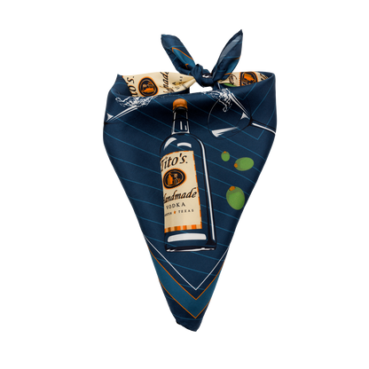 tied up Blue silk scarf with a design of Tito's Handmade Vodka bottles and martini glasses overflowing with olives