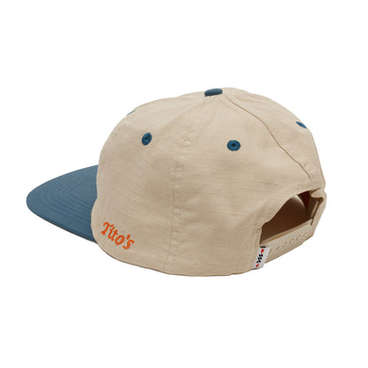 Beige and blue cap with 'Tito's' word mark on left side of hat