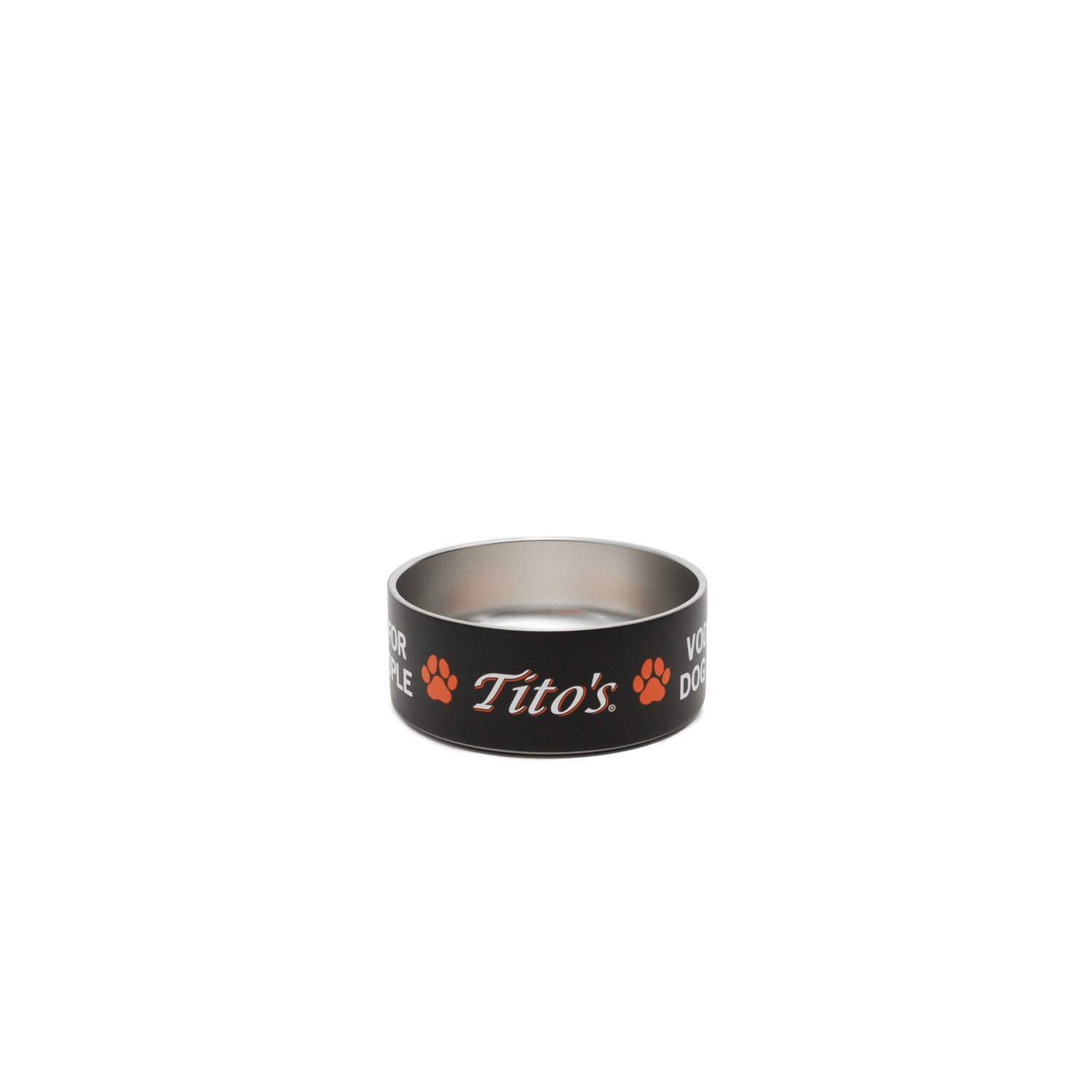 A black and stainless steel dog bowl featuring the orange and white 'Tito's' logo, Vodka for Dog People words, and paw prints on the exterior, set against a plain white background.