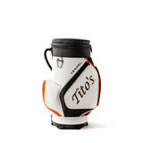 Side view of orange, black, and white VESSEL Cool Caddy with Tito's and VESSEL wordmark