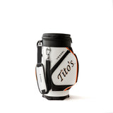 Side view of orange, black, and white VESSEL Cool Caddy with Tito's and VESSEL wordmark and padded shoulder strap