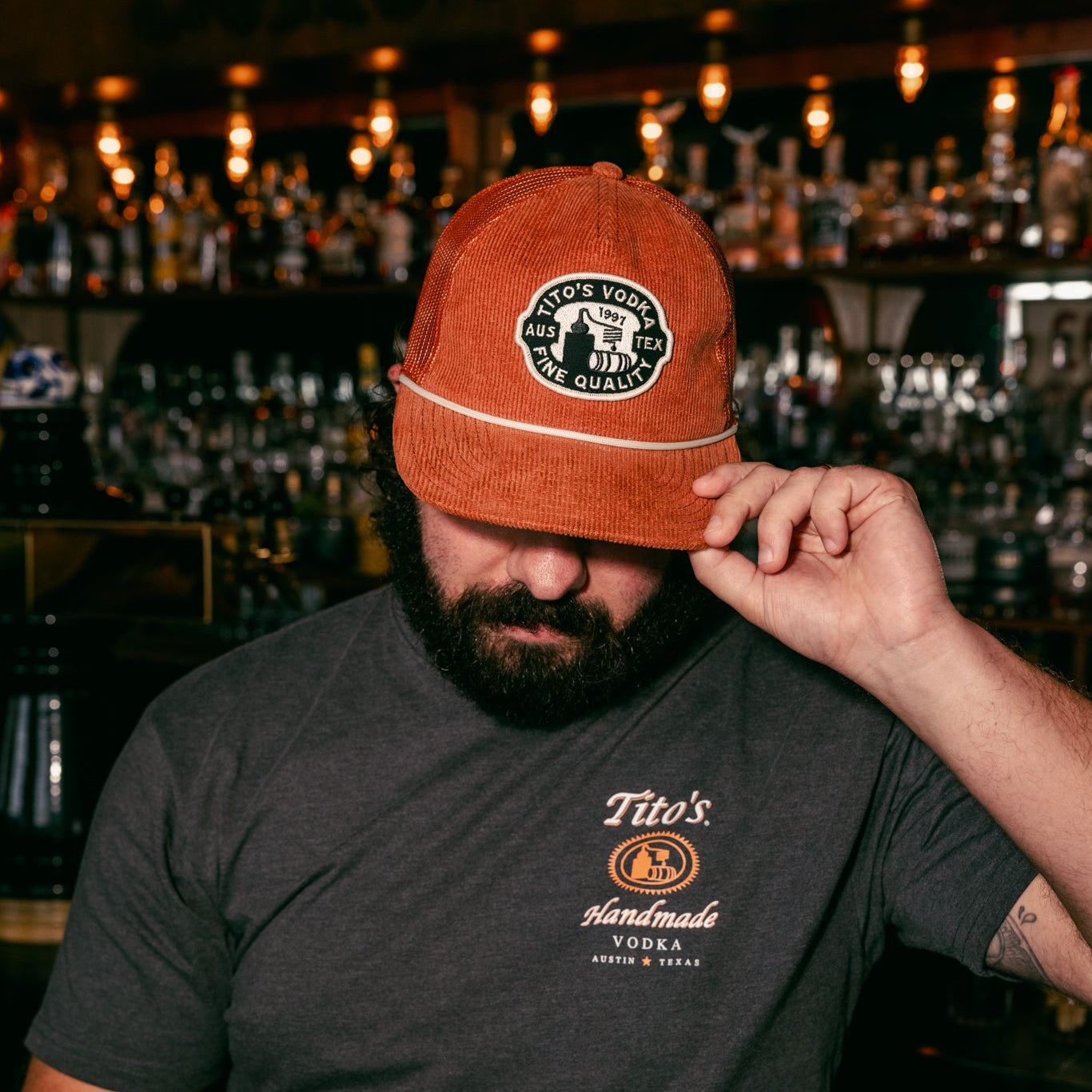 Person wearing Tito's Copper Cap in a bar 