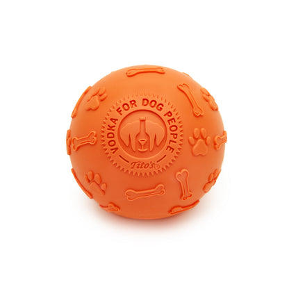 Orange rubber ball with Tito's Vodka for Dog People logo and paw print and dog bone designs