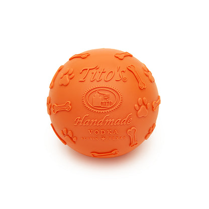 Orange rubber ball with Tito's Handmade Vodka logo and paw print and dog bone designs