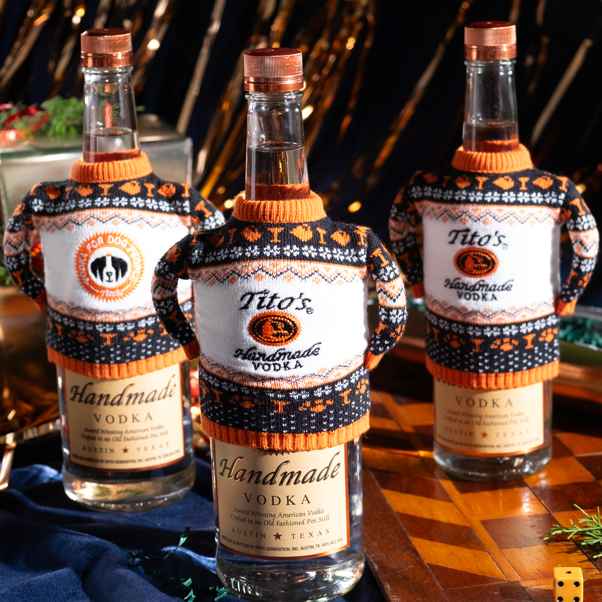 Three Tito's Handmade Vodka bottles with bottle sweaters