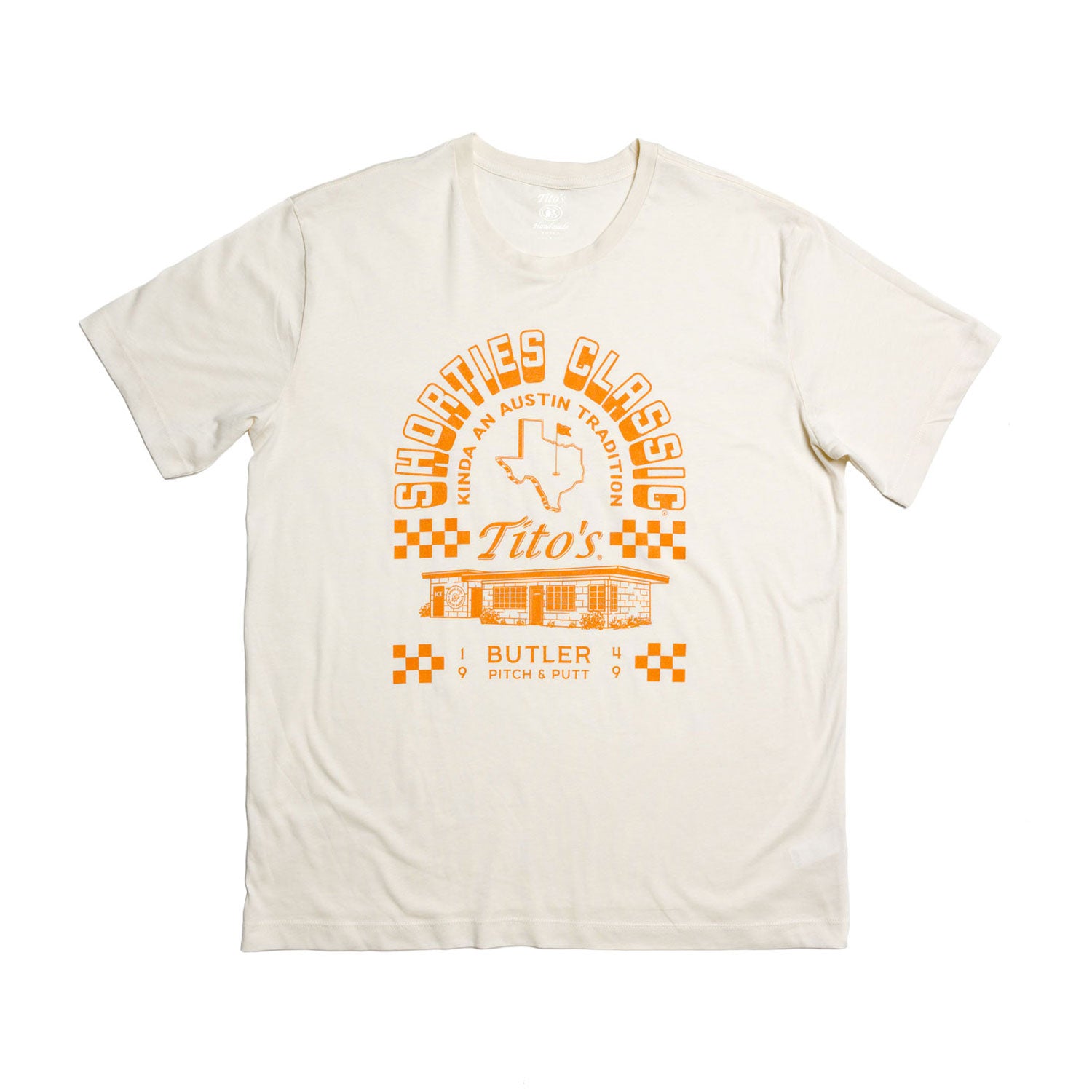 Front of cream colored short-sleeve t-shirt with Tito's Shorties Classic and Butler Pitch & Putt illustration