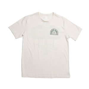 Front of cream colored short-sleeve shirt with Tito's Shorties Classic and Austin, Texas design on left chest