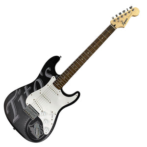 Black and white electric guitar with Tito's wordmark