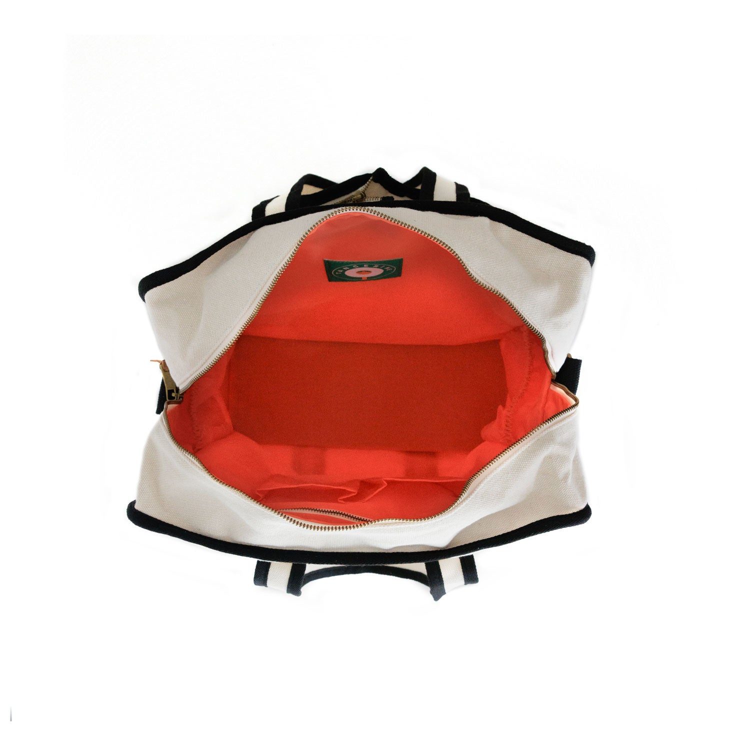 Inside of Tito's X Tangerine Pickleball Bag with zipper enclosure and orange interior fabric
