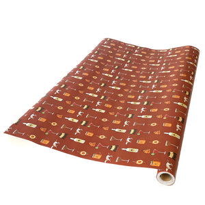 Rust colored wrapping paper with illustrations of cocktails, dogs, and Tito's Handmade Vodka bottles