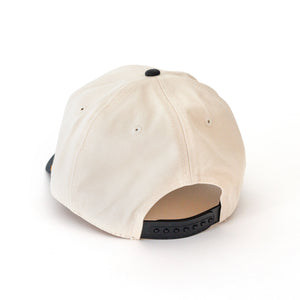 Back view of ivory twill hat with black snap closure