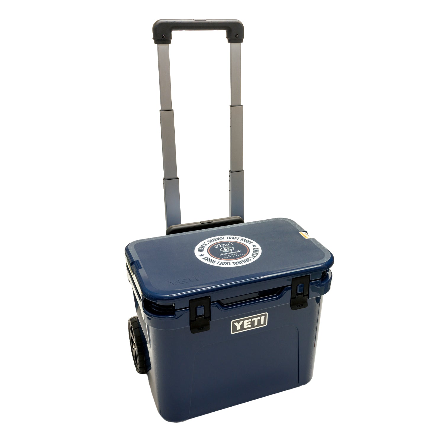 Blue YETI cooler with wheels with Tito's Handmade Vodka logo on lid
