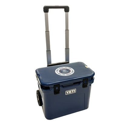 Blue YETI cooler with wheels with Tito's Handmade Vodka logo on lid