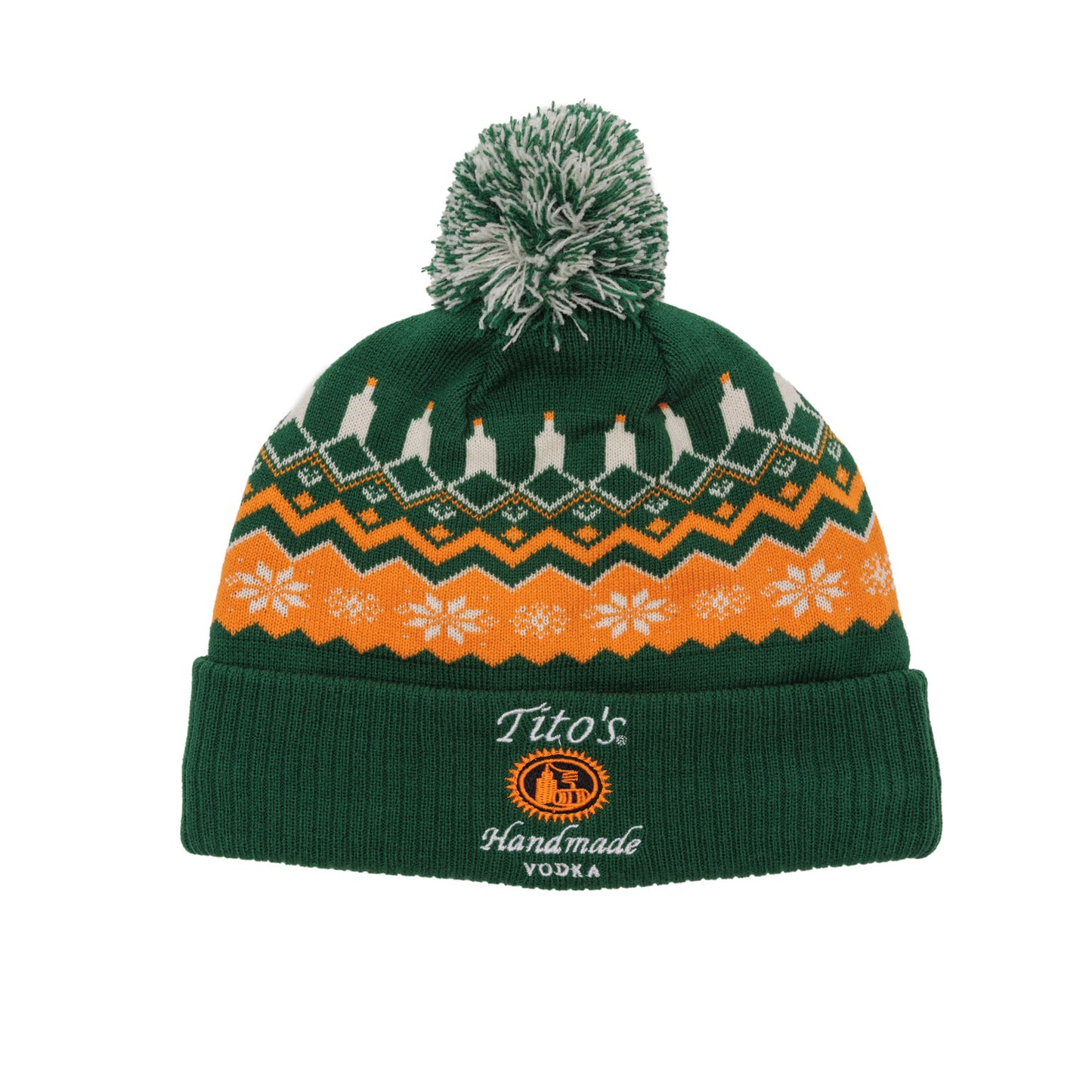 Green knit beanie with pom poms with orange and white festive patterns and Tito's Handmade Vodka logo embroidered on the cuff. 