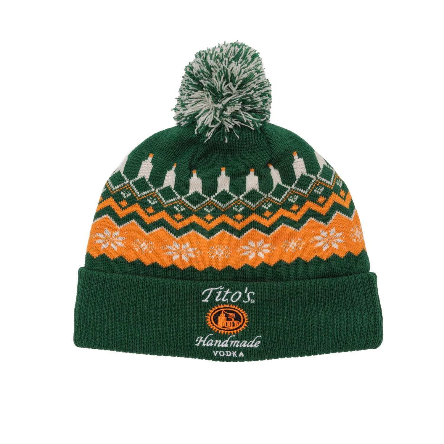 Green knit beanie with pom poms with orange and white festive patterns and Tito's Handmade Vodka logo embroidered on the cuff. 