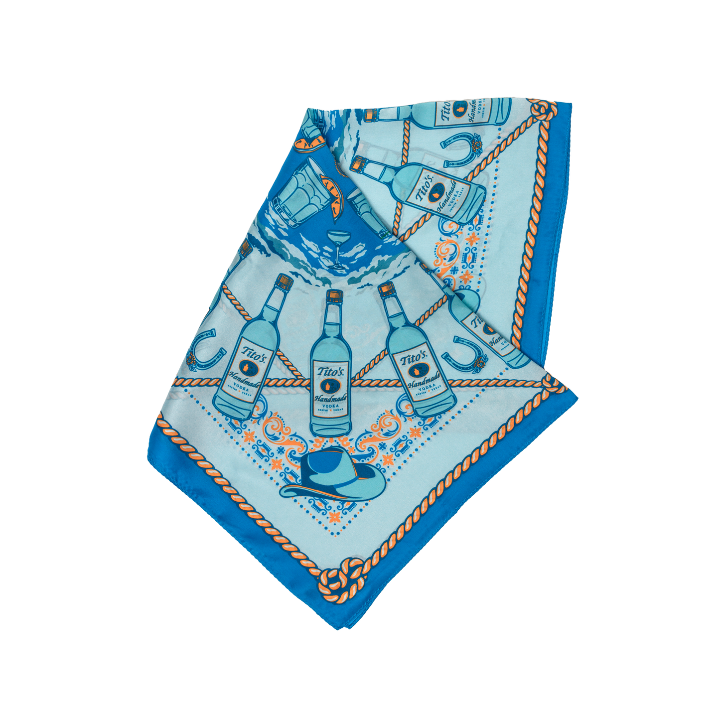 Blue silk scarf with pattern of Tito's Handmade Vodka bottles, cowboy hats, cocktails, and rope folded into a triangle