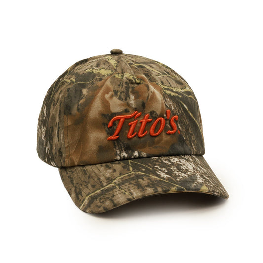 A baseball cap in a brown and green camouflage pattern, featuring the word 'Tito's' embroidered in orange across the front, set against a plain white background.