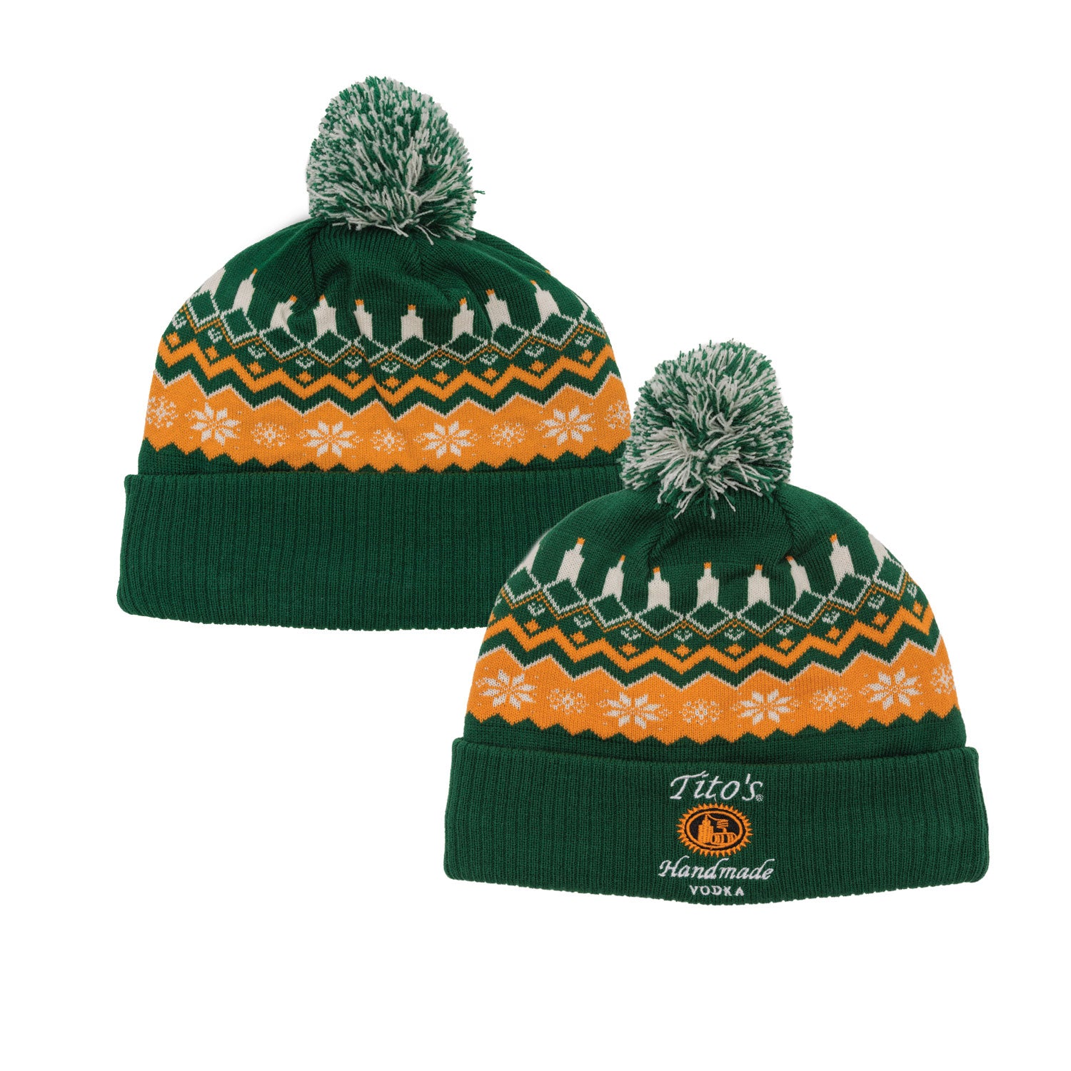 Front and back view of two green and orange beanies with festive patterns and pom-poms. The front cuff has the Tito's Handmade Vodka logo.