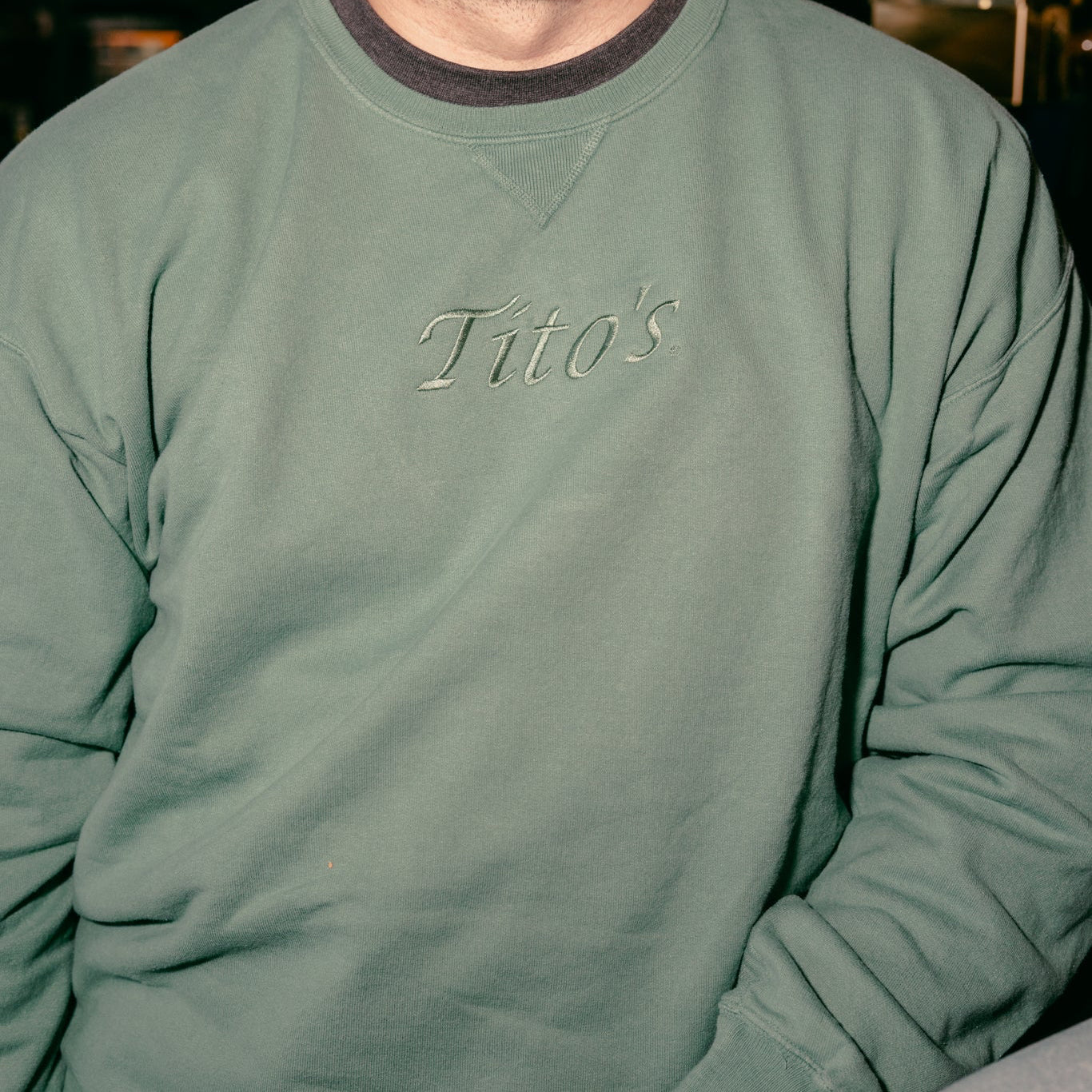 Person wearing the evergreen colored Tito's Classic Crewneck 