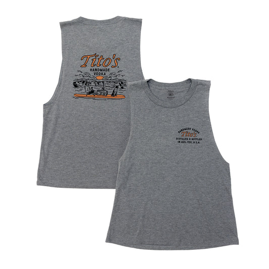 Front and back view of heathered grey ladies tank top. Front has a small Tito's logo on the left chest and the back has an image of a guy and a dog on a paddle board with Tito's Handmade Vodka above it 