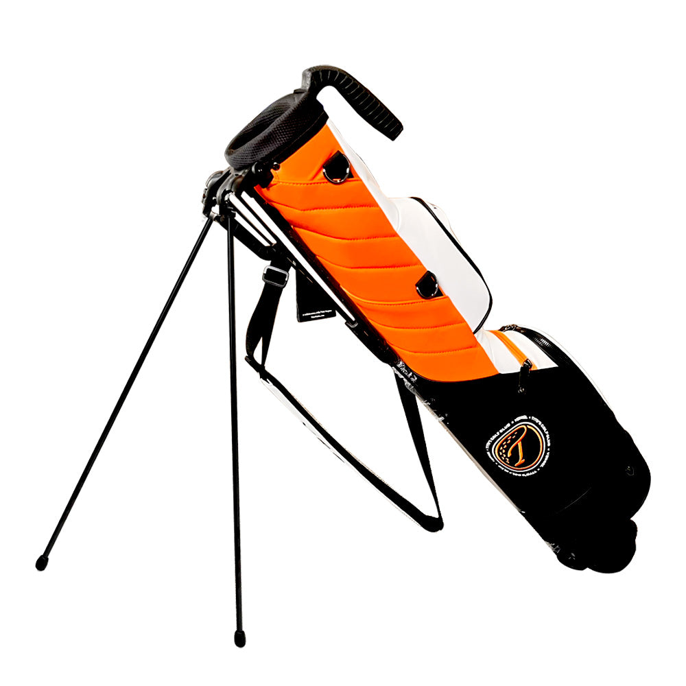 Vessel Orange, black, and white pencil golf bag with a stand with the Tito's Golf Club logo on the black pocket