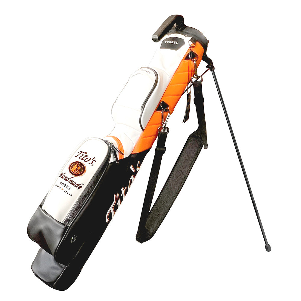 Vessel pencil bag with orange, white, and black leather details and Tito's logo on the front pocket