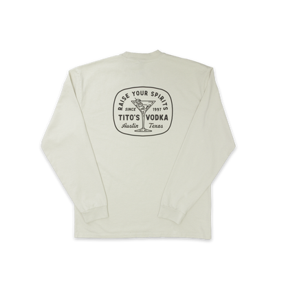 Back view of bone colored longsleeve with design of a martini glass with olives and says Raise Your Spirits, Tito's Vodka, Austin, Texas Since 1997