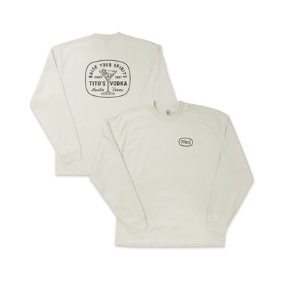 Front and back view of bone colored longsleeve with Tito's logo on the front chest. Back design has a martini glass with olives and says Raise Your Spirits, Tito's Vodka, Austin, Texas Since 1997