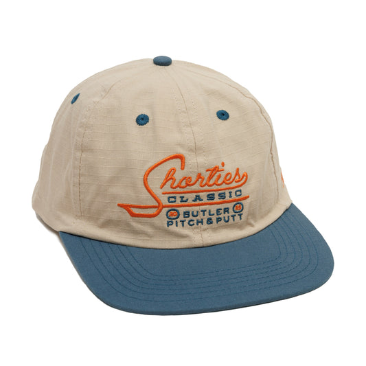 Beige and blue cap with 'Shorties Classic Butler Pitch & Putt" logo