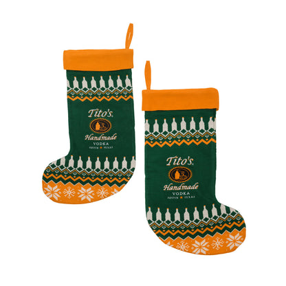 Two green and orange Tito's Handmade Vodka stockings with the same festive patterns on both sides. 