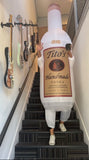 Person wearing Tito's inflatable bottle costume walking down stairs 