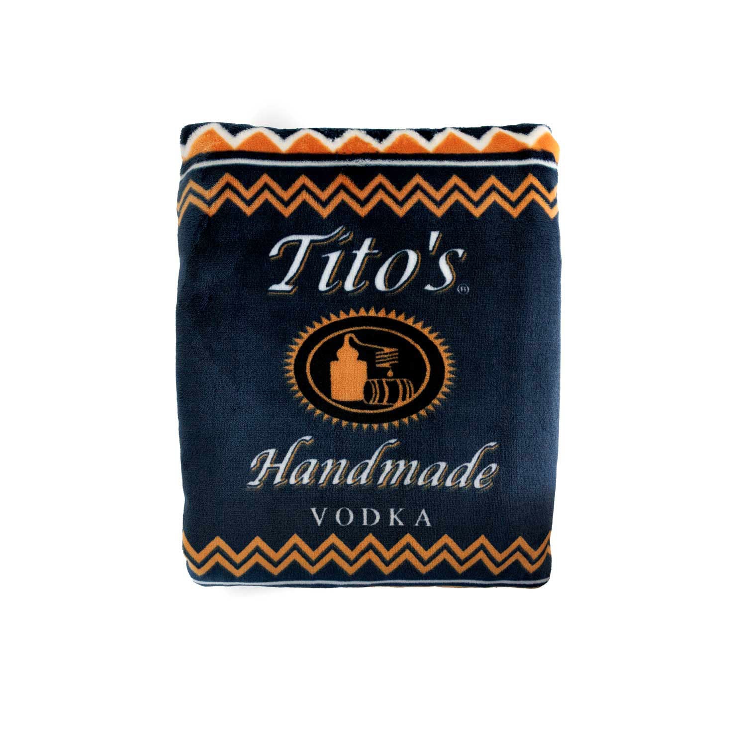 Folded view of navy blue and orange blanket with Tito's Handmade Vodka logo