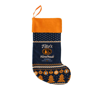 Front view of navy, white, and orange stocking with Tito's Handmade Vodka logo, and designs of snowflakes, paw prints, trees, and martini glasses