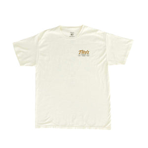 Front of cream short sleeve shirt with orange Tito's wordmark