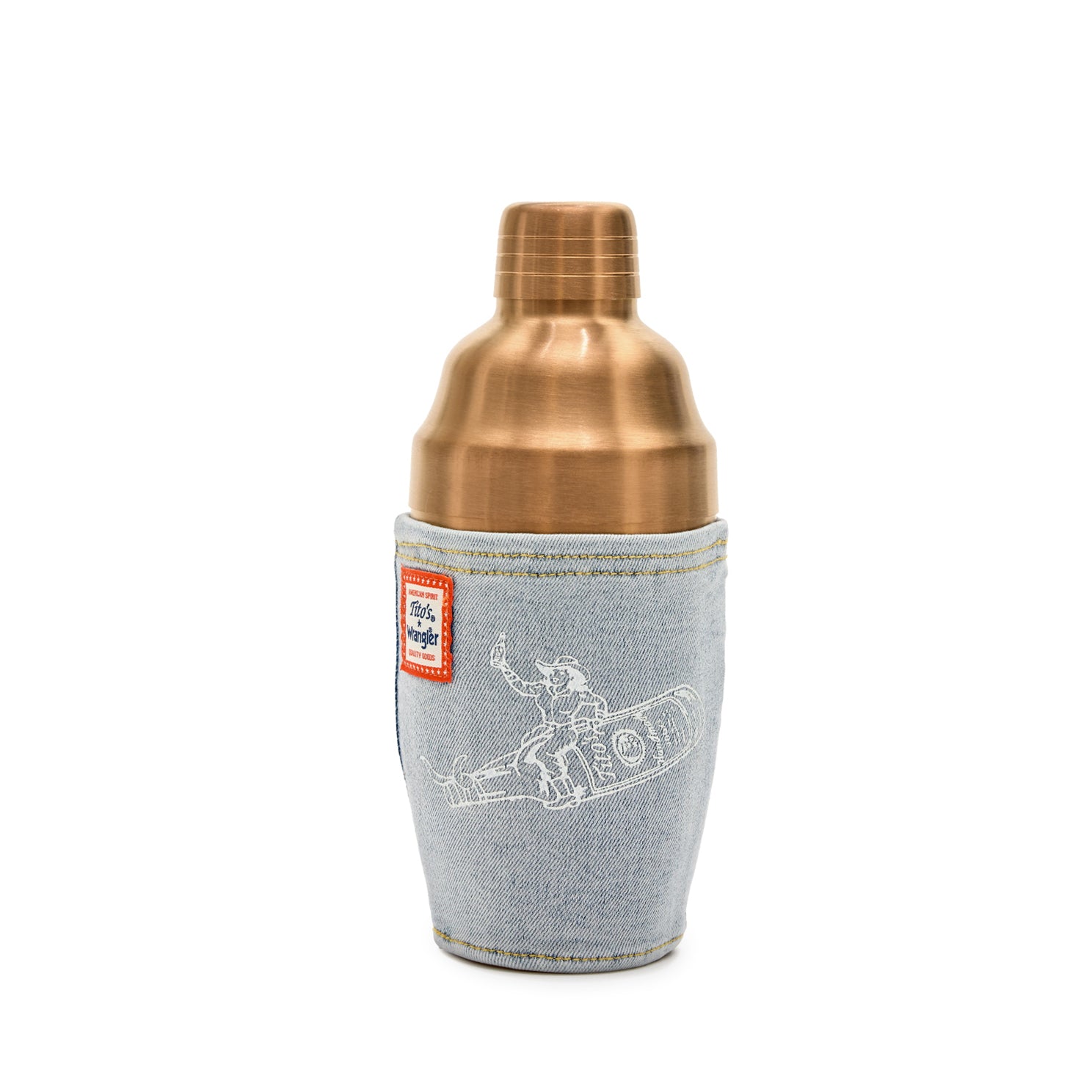 Front view of a 3 piece copper shaker with a denim wrap with an image of a cowgirl riding a Tito's bottle with horns and a patch with Tito's and Wrangler branding