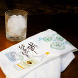 Tea towel and cocktail sitting on a brown table