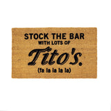 Coconut fiber door mat that reads "stock the bar with lots of Titos (fa la la la la)"