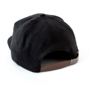  Back view of black wool hat with with brown leather adjustment