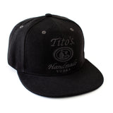 Tito's Handmade Vodka logo embroidered in black on front of black flat bill hat 