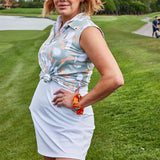 Woman wearing the Tito's X William Murray Bottle in Disguise Golf Polo Tank on a golf course
