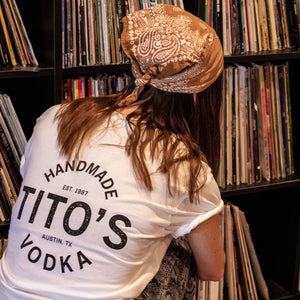 Girl wearing white Tito's All-Time Favorite Tee 
