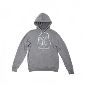Front of light gray hooded sweatshirt with white drawstring and white Tito's Handmade Vodka logo