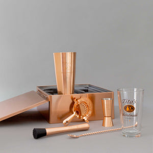 Tito's Vodka copper gift box with copper-plated shaker, strainer, muddler, spoon, jigger, and pint glass